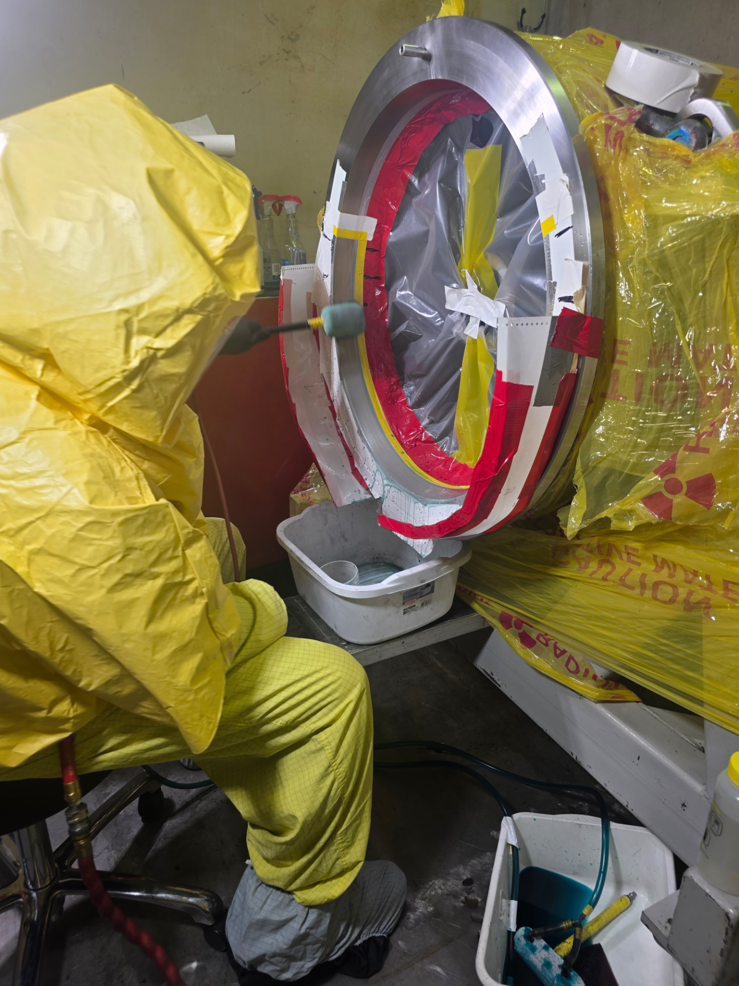 Technician performing precision brush plating on a steel shaft